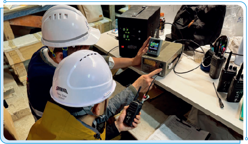 Staff members of OFCA conducting an inspection on a mobile radio system in a construction site.