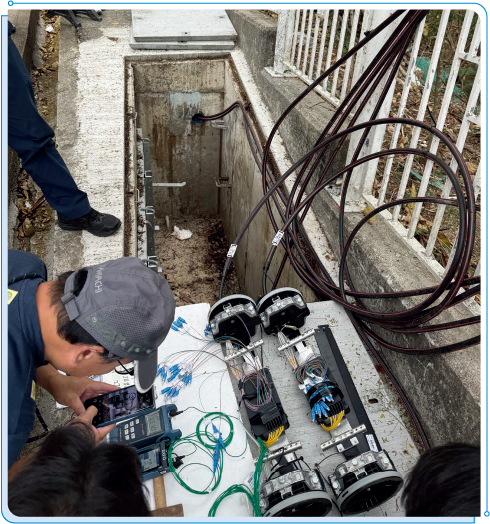 Staff members of OFCA carrying out an inspection on the optical fibre cables installed under the Subsidy Scheme to Extend Fibre-based Networks to Villages in Remote Areas.