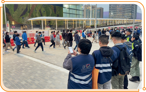 Staff members of OFCA monitoring 5G performance when spectators leaving Kai Tak Sports Park in a stress test event.